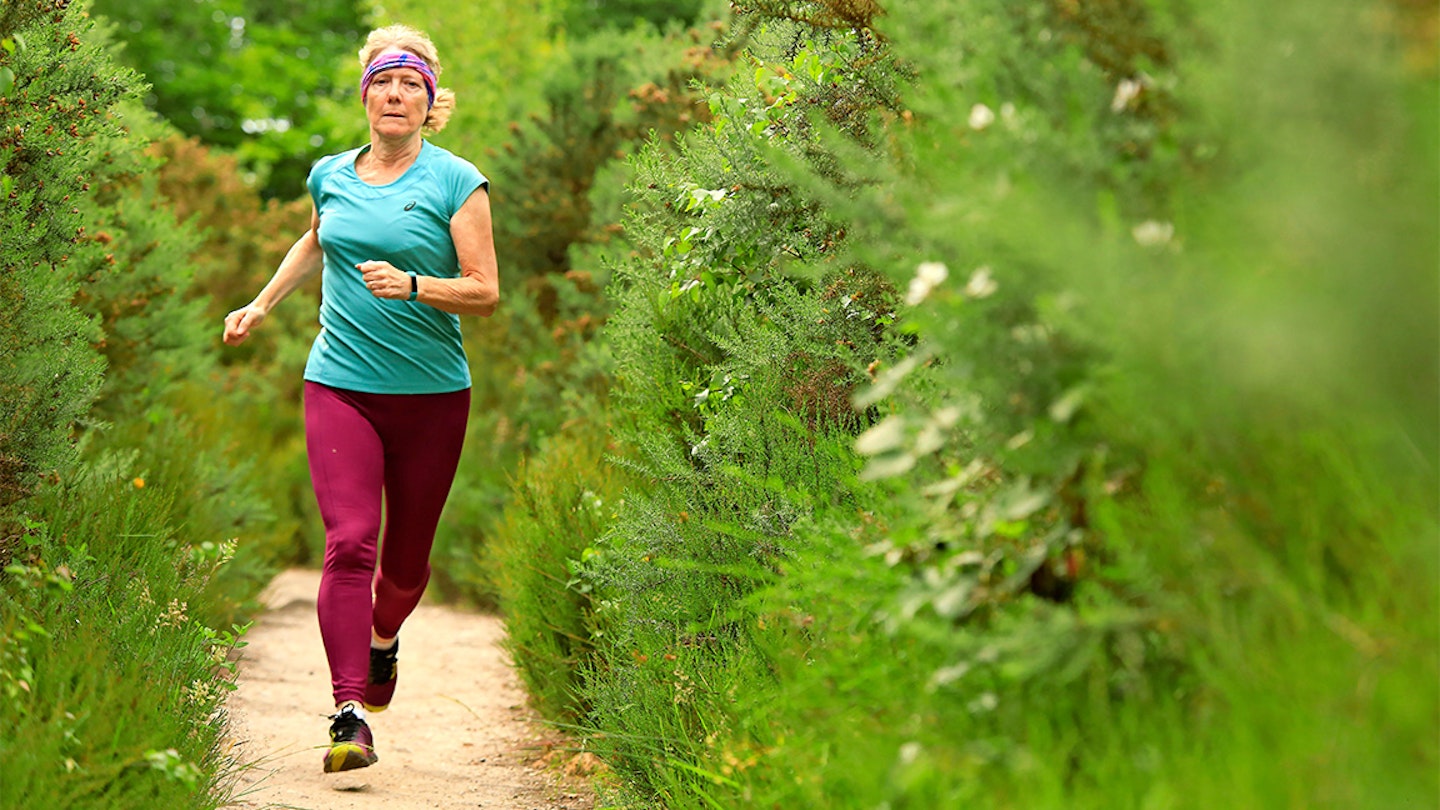 woman runs through a forest