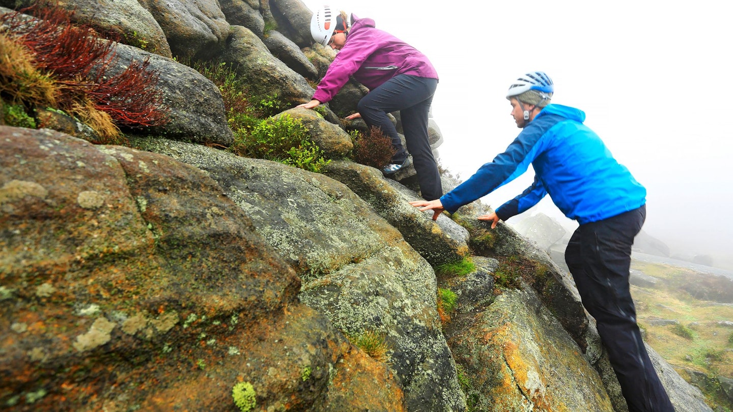 Two hikers climbing a rock face, Lake District