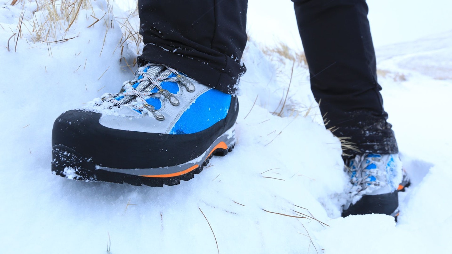 Closeup of winter hiking boots in the snow
