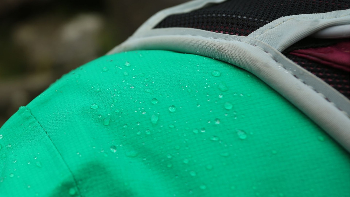 Closeup of rain beading on a waterproof jacket