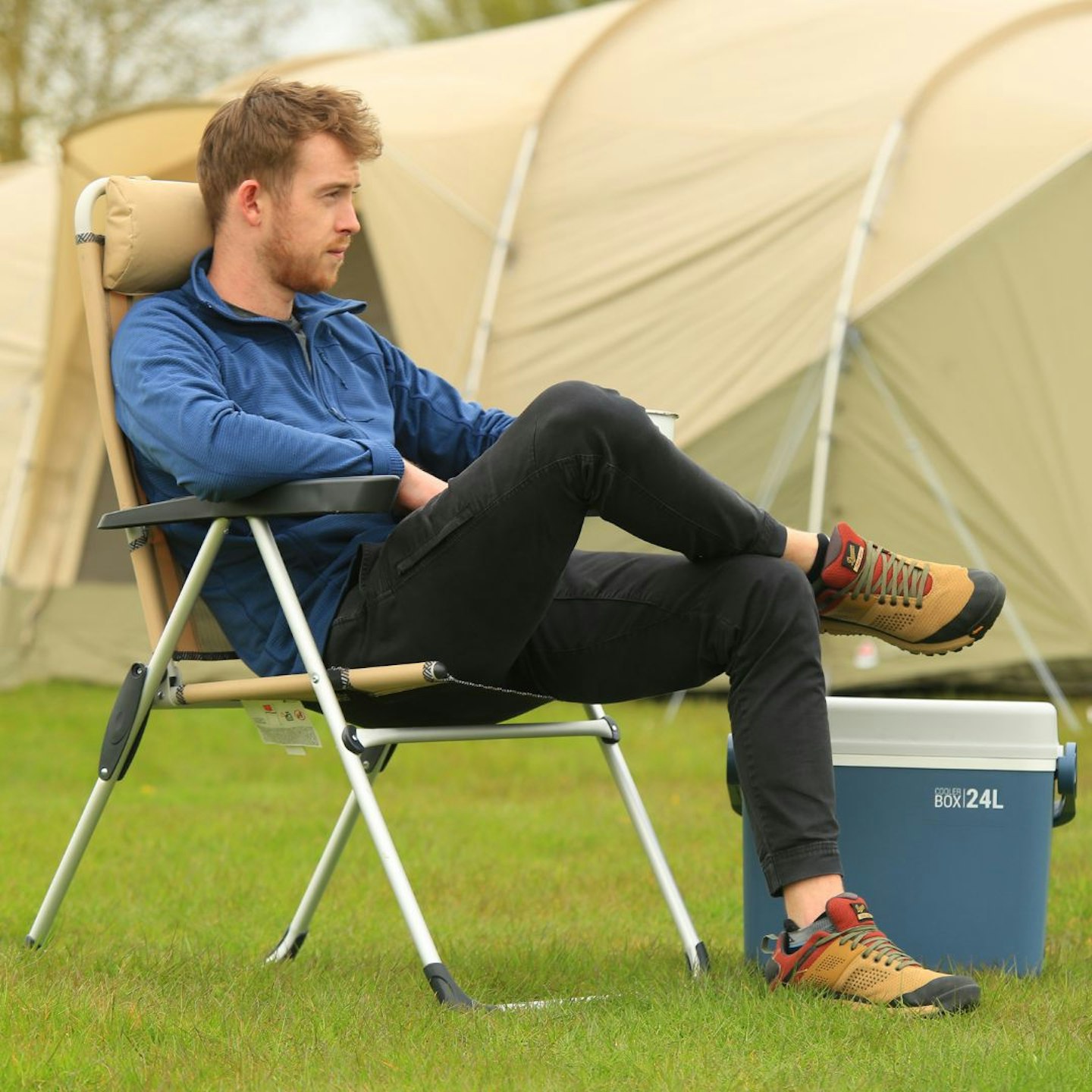 Camper sitting in a QUECHUA Camping Comfortable Reclining Folding Armchair