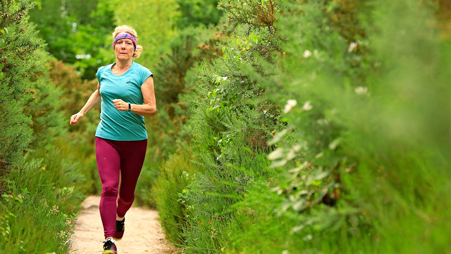 woman runs through forest