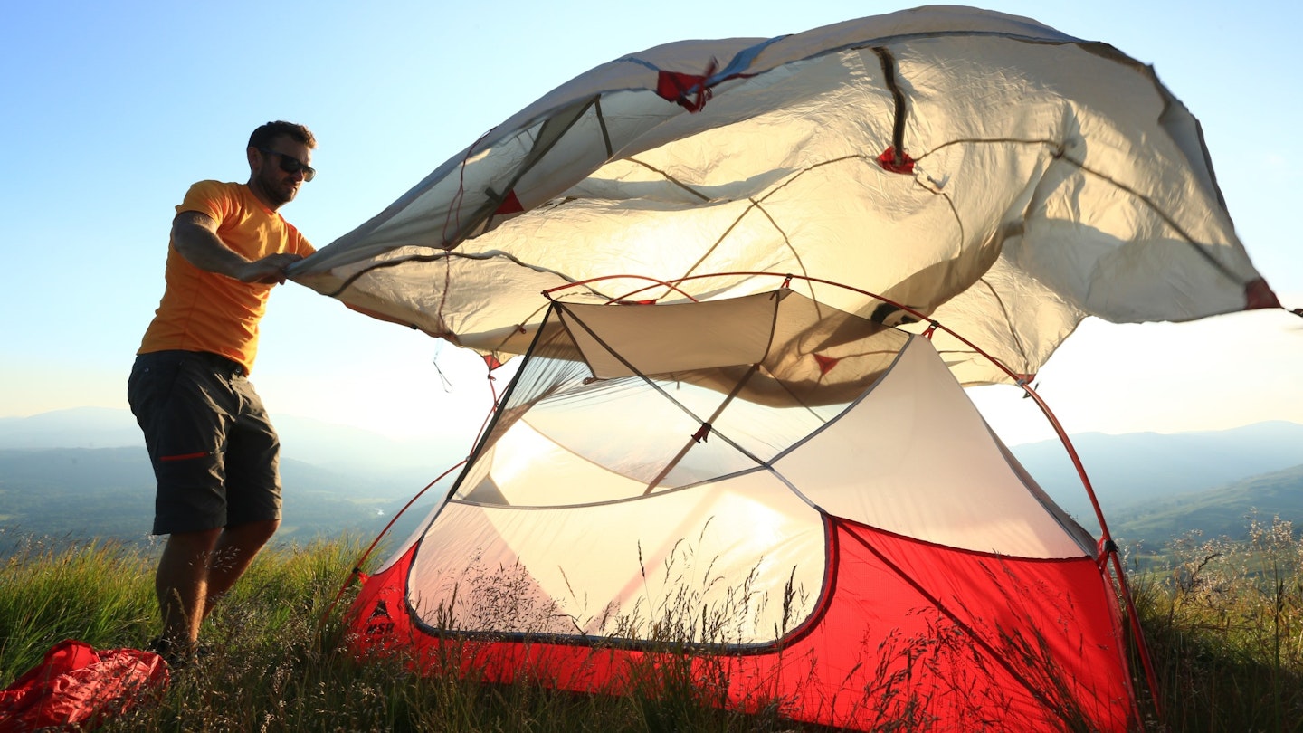 Putting a flysheet over a tent inner