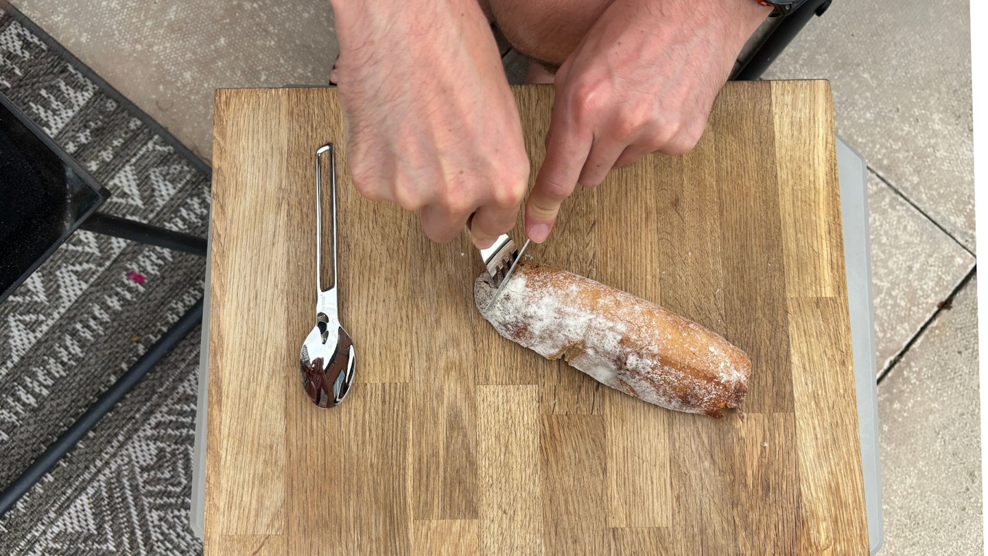 Cutting sourdough with camping cutlery