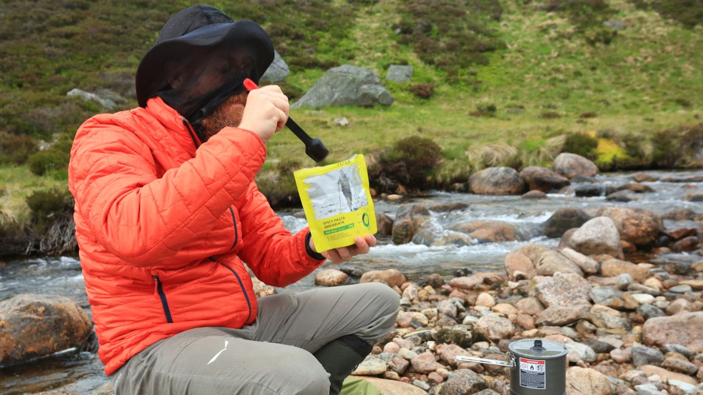 Eating food at camp at Carn Fiaclach, Scotland
