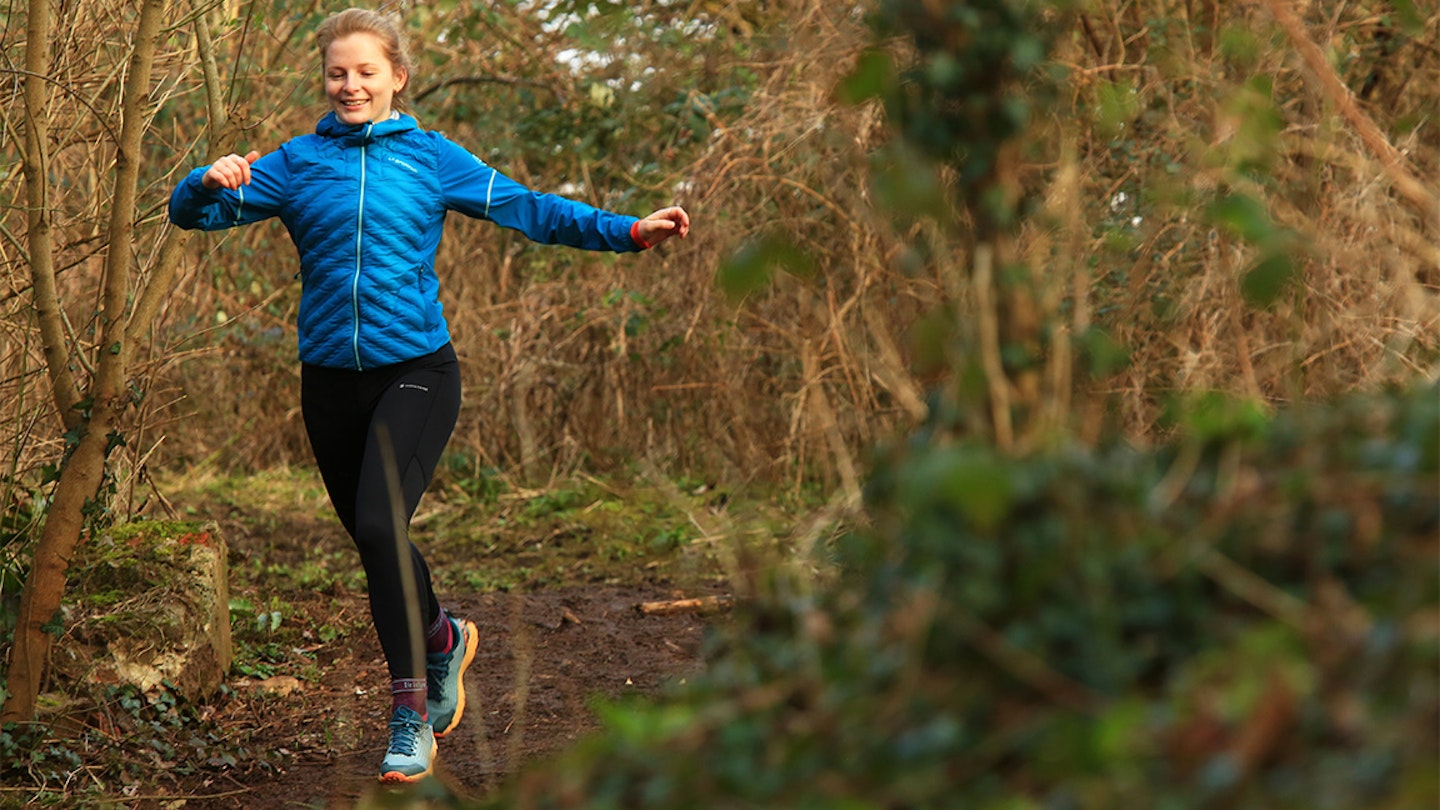 woman runs through forest