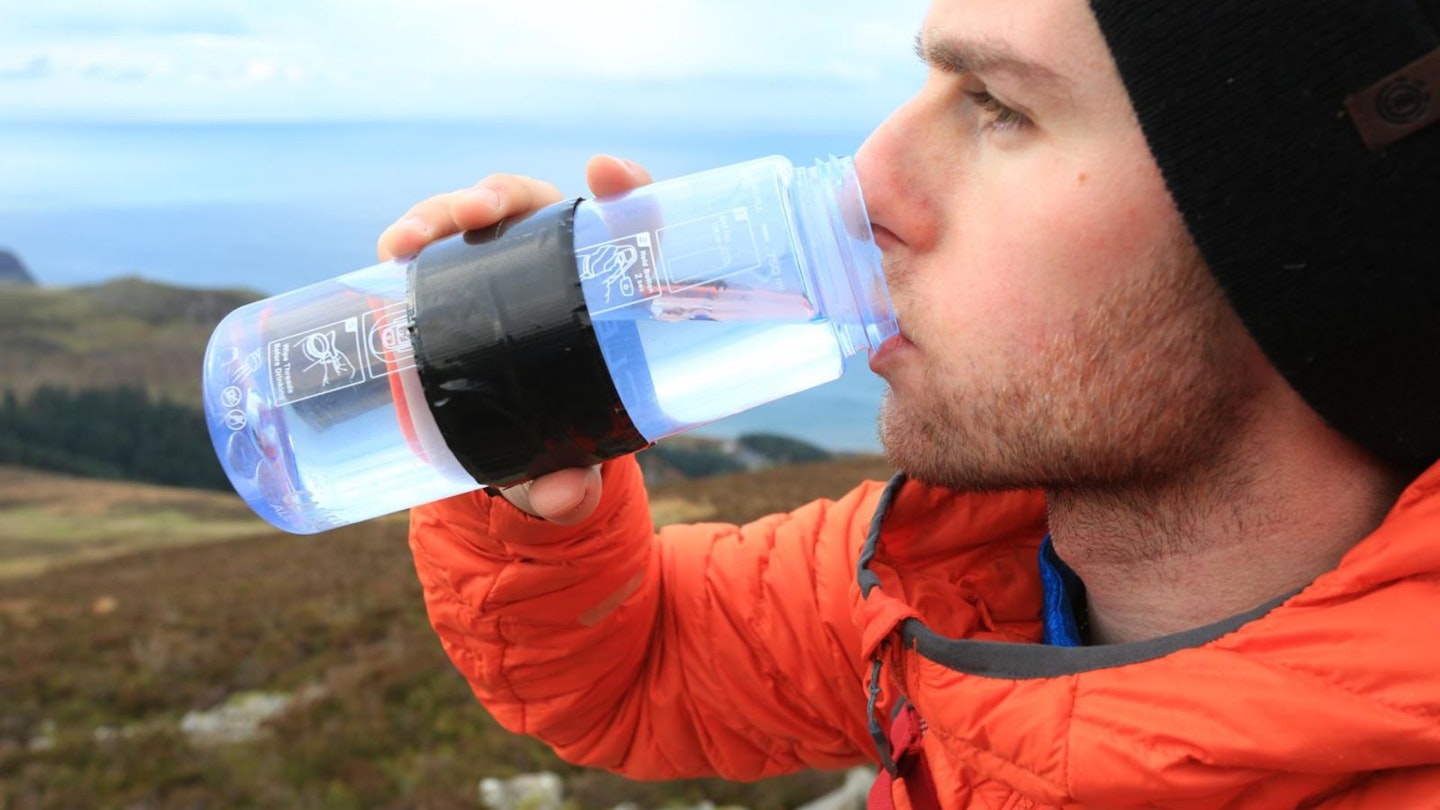 Hiker drinking from a water bottle