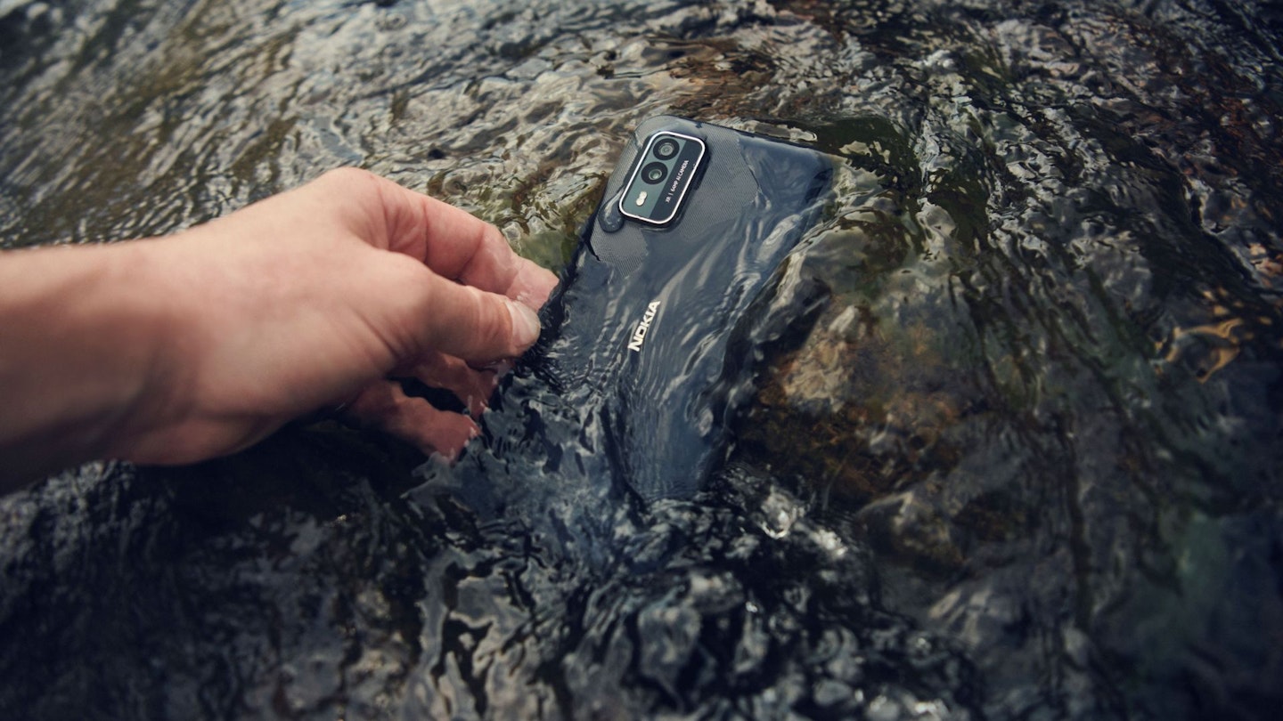 Hand gabbing XR21 submerged underwater