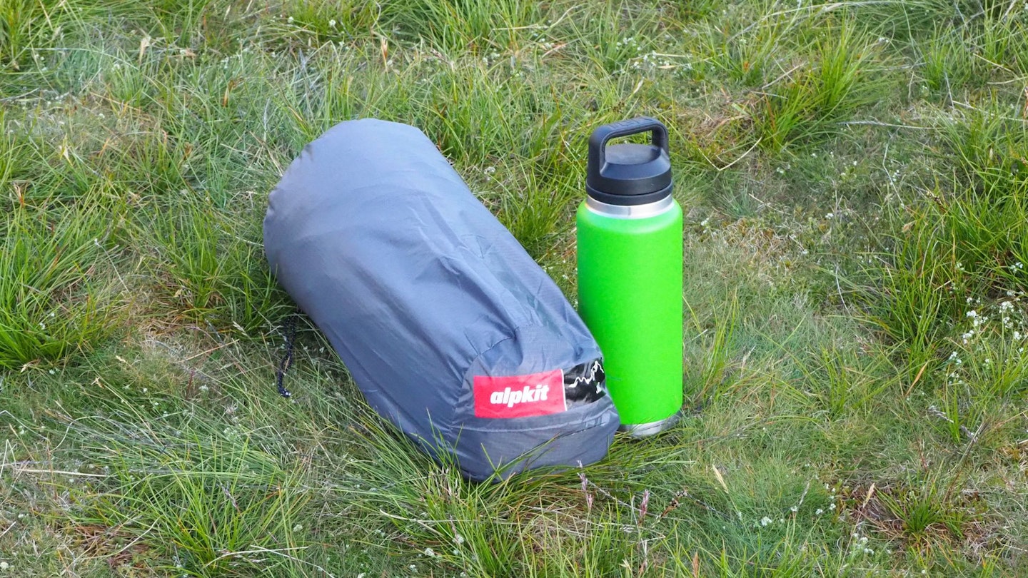 Alpkit Jaran 3 packed away, next to water bottle for size comparison