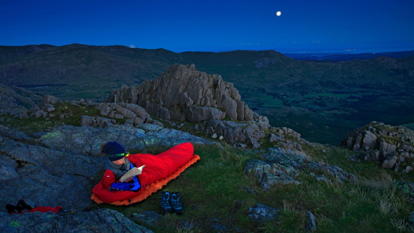 Hiker using a bivvy at dusk