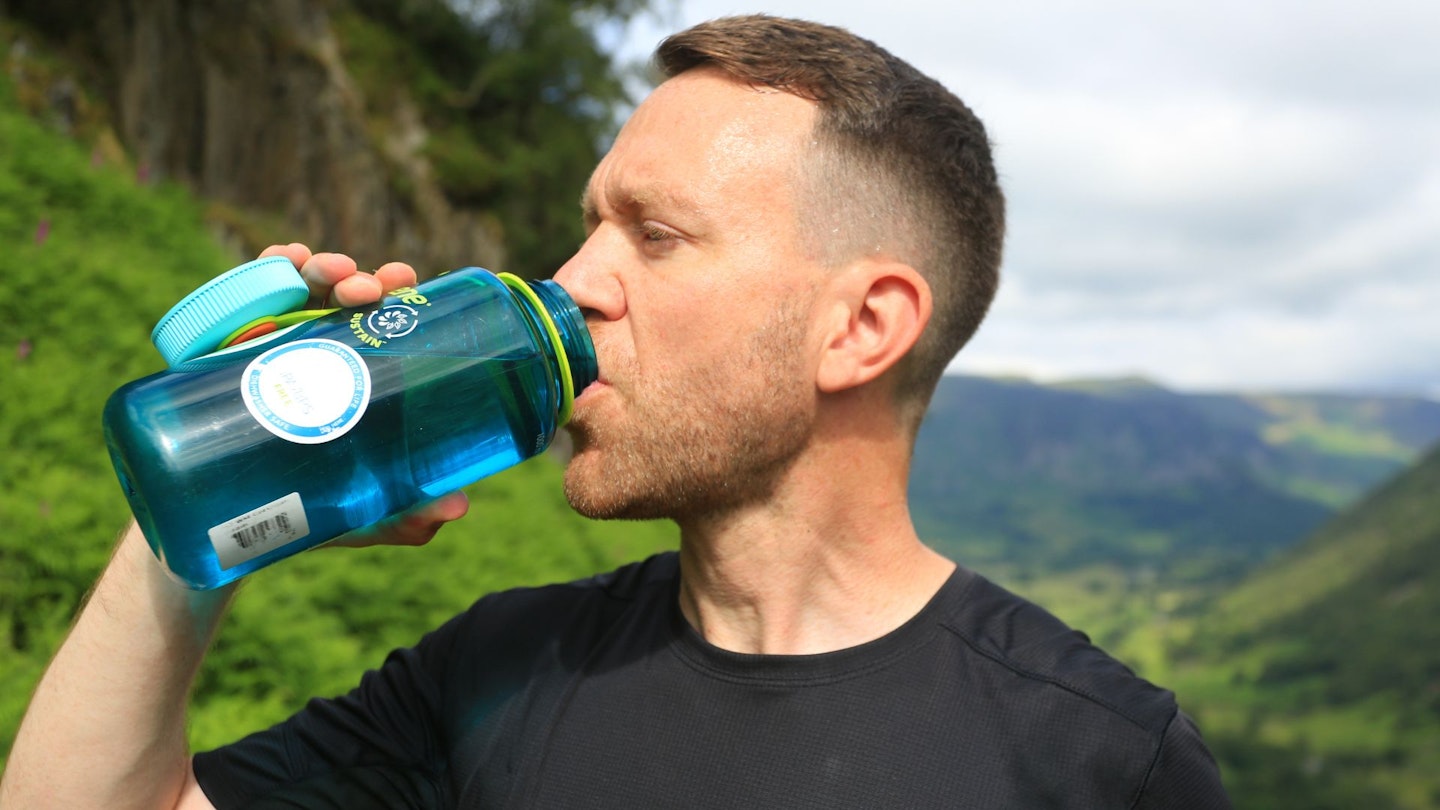 Hiker drinking from a water bottle