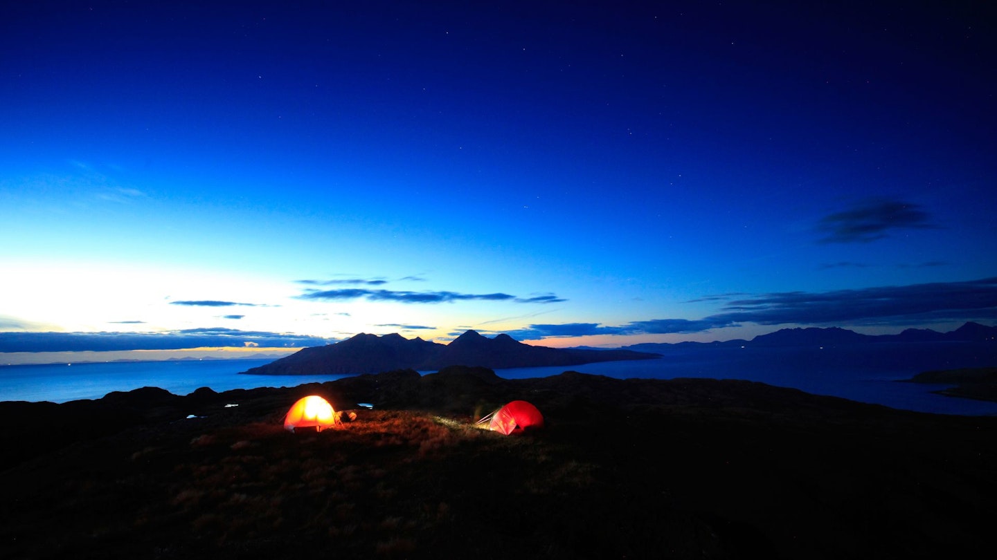 Two tents wild camping at dusk in Scotland