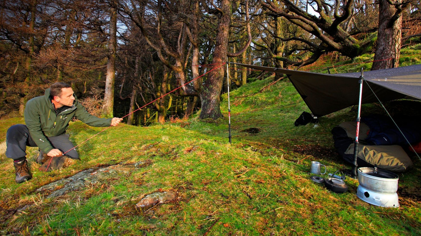 Hiker rigging a tarp