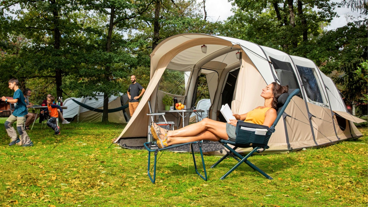 Family relaxing by their Decathlon tent