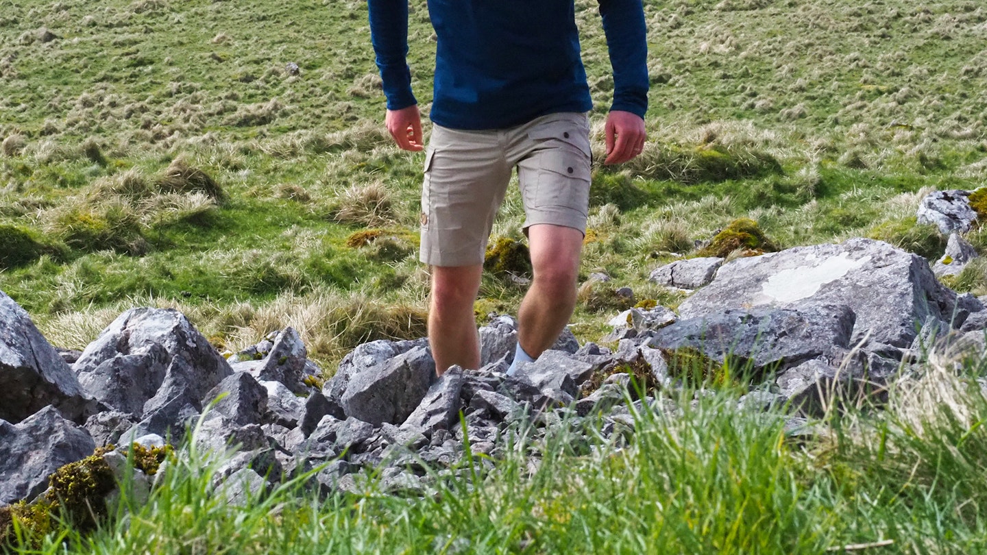 Hiker walking up a hill wearing Fjallraven Vidda Pro Lite Shorts