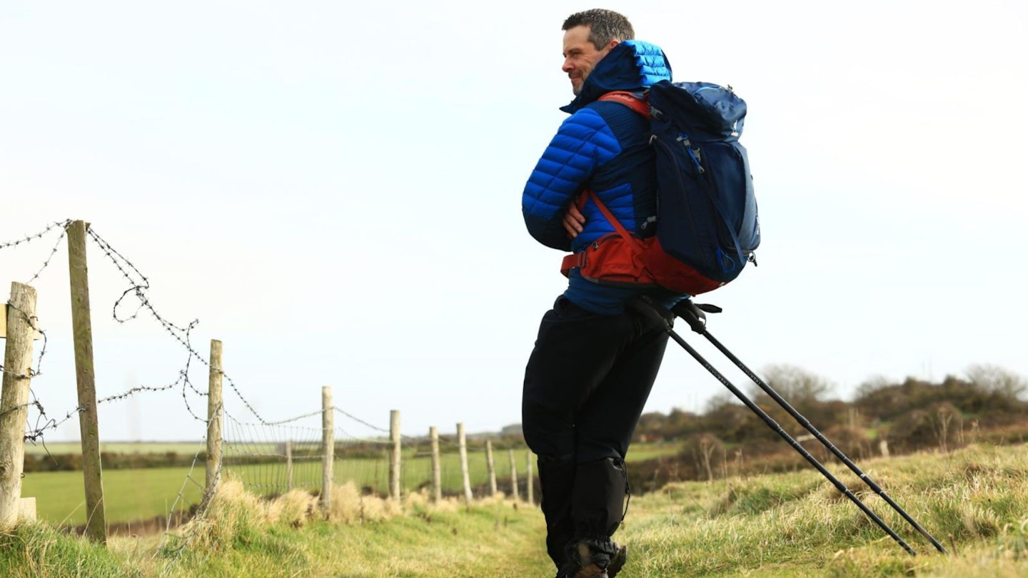 Hiker leaning on walking poles