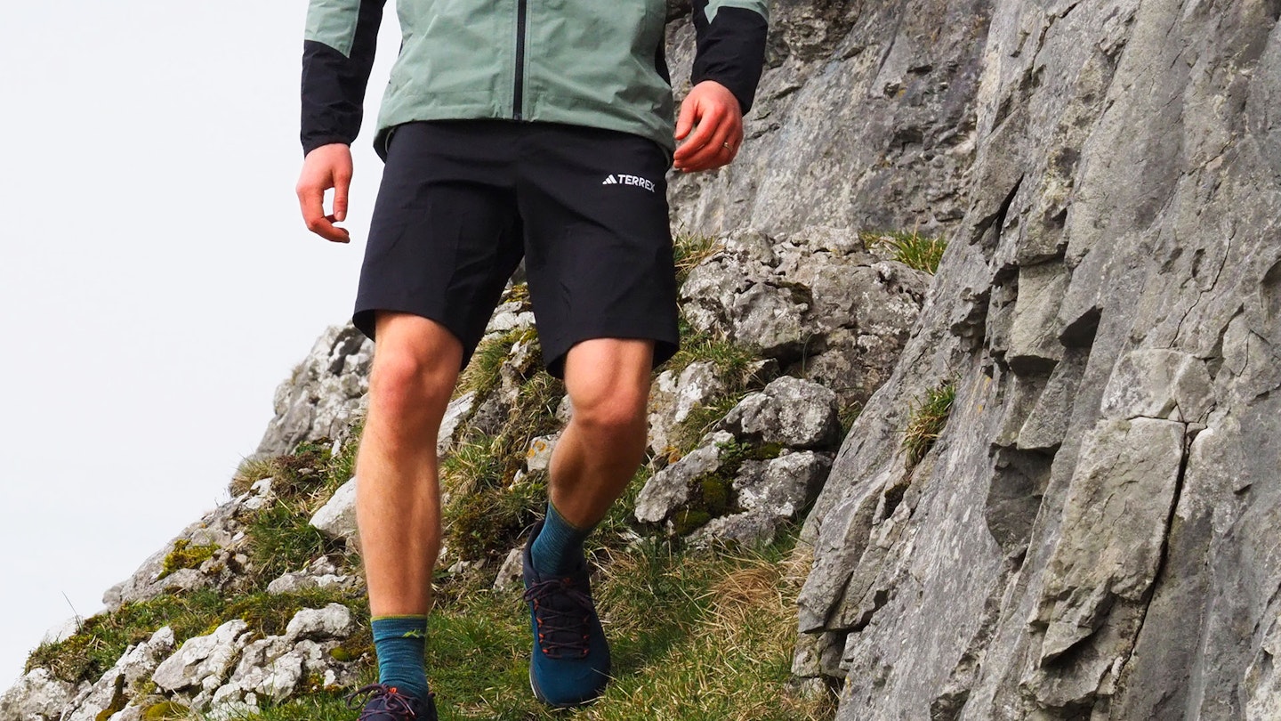Hiker walking downhill wearing Adidas Terrex Xperior Mid Shorts