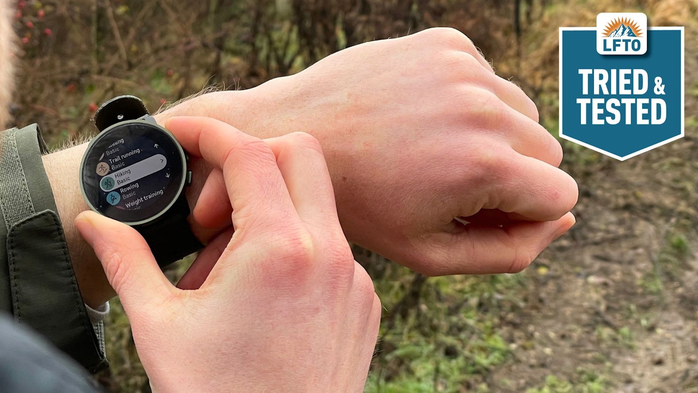 Looking over the shoulder of a hiker using an outdoor watch