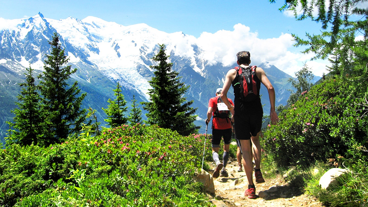 two runners along an alpine trail in the alps