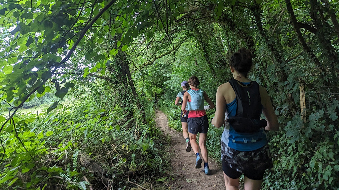 fastpacking women running in the forest