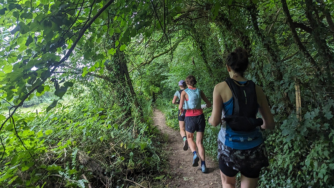 fastpacking women running in the forest