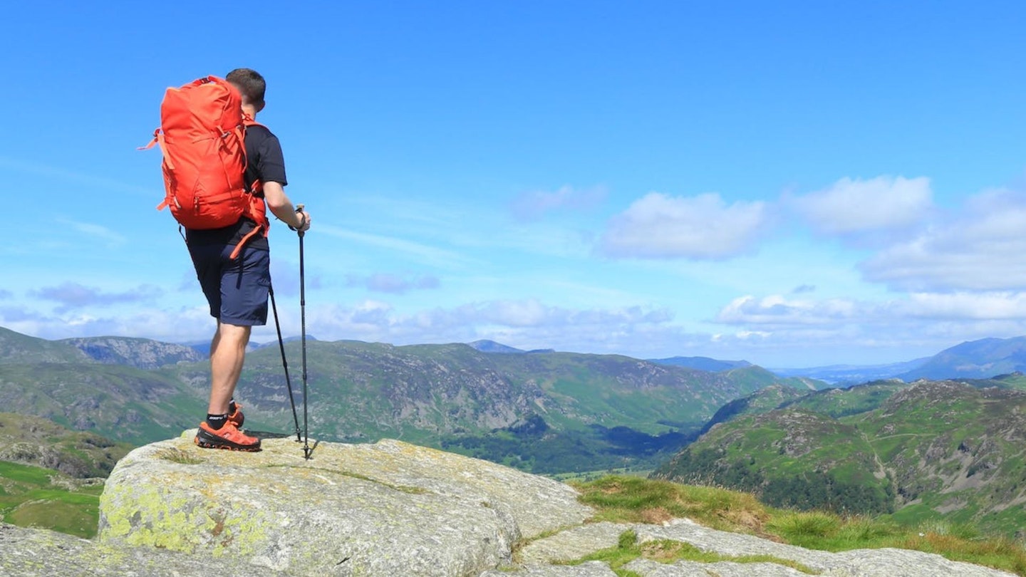 Standing on a summit wearing hiking shoes