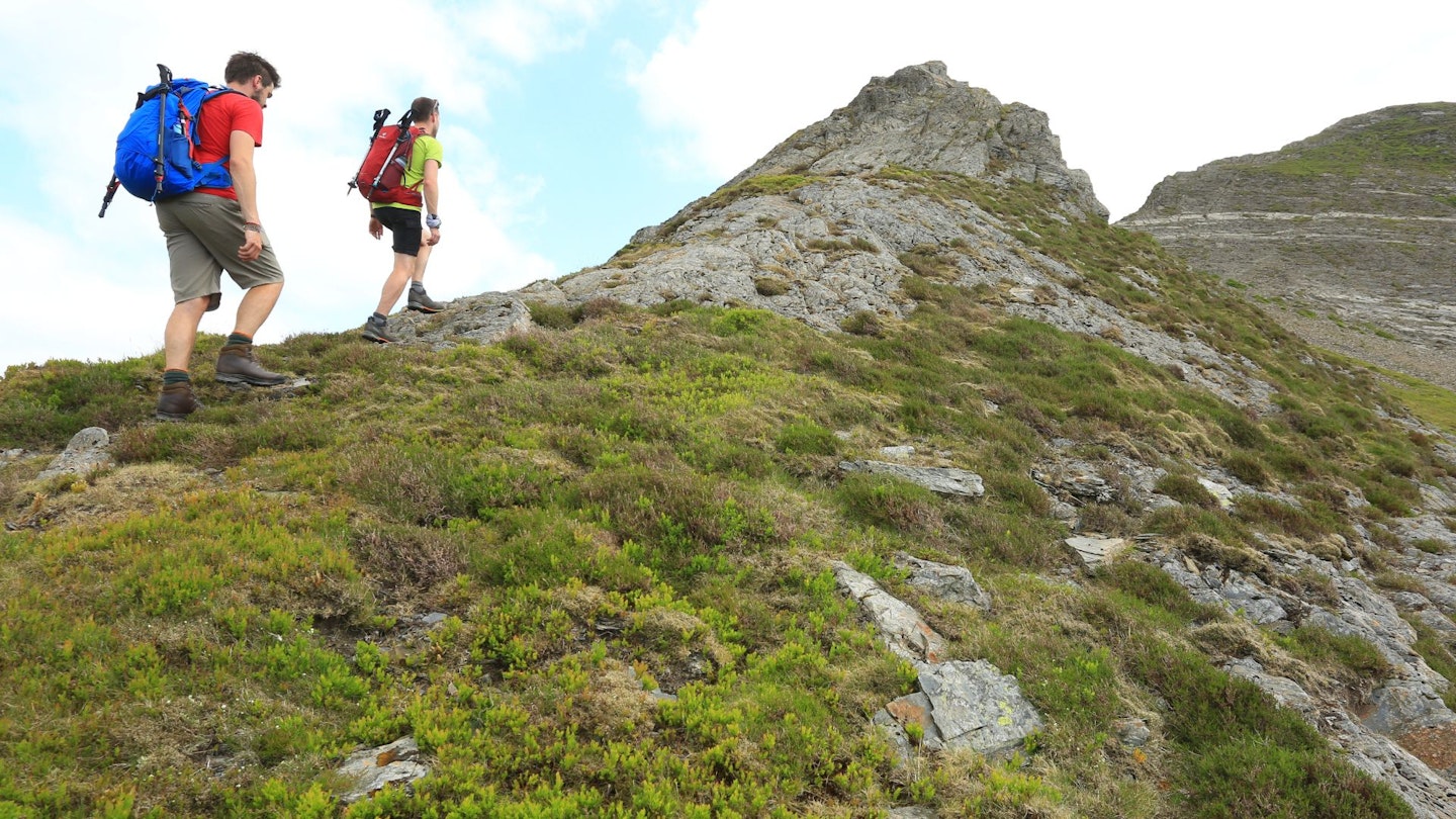 Hikers on Hopegill Head ridge, carrying overnight backpacks