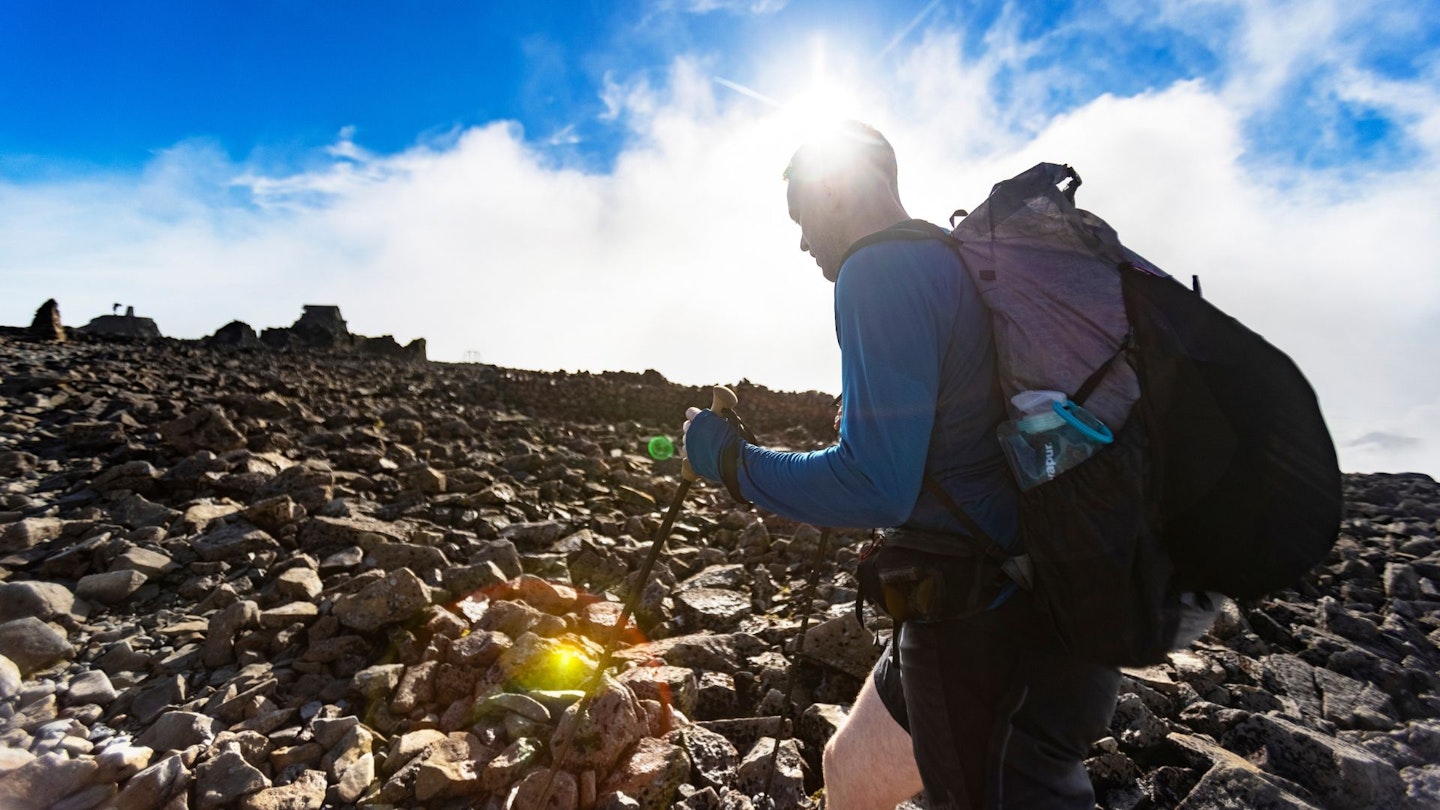 Our ultralight backpacker climbing a hill