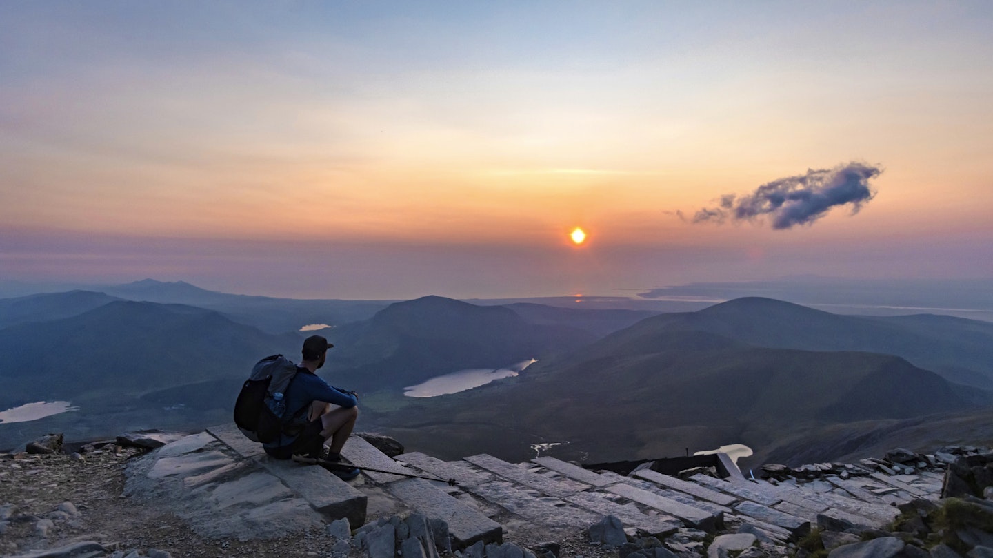 Our ultralight backpacker watching sunset after completing 3 peaks challengs