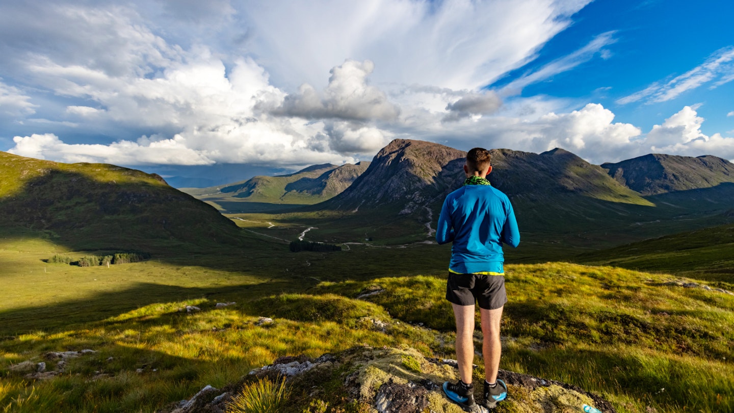 Our ultralight backpacker on a hill looking at the view