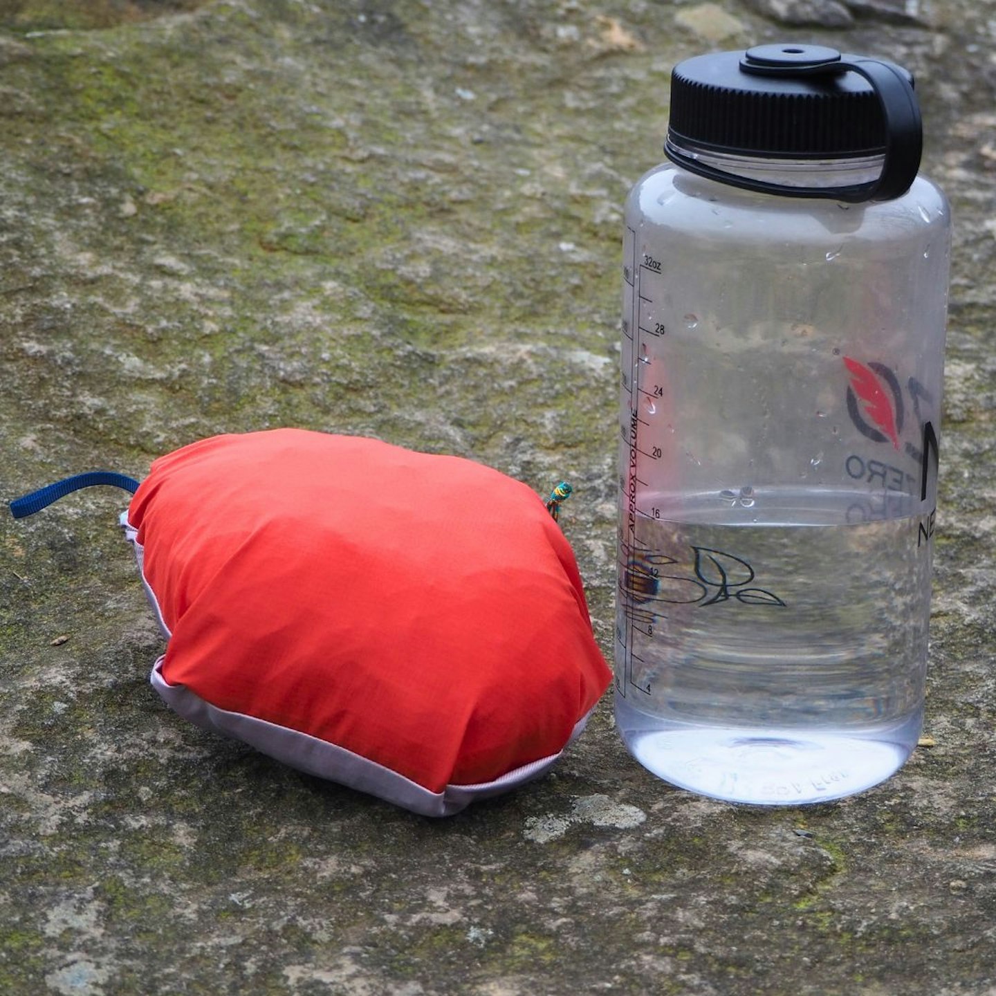 Patagonia Storm Racer Waterproof Jacket in stash pocket next to drink bottle for scale
