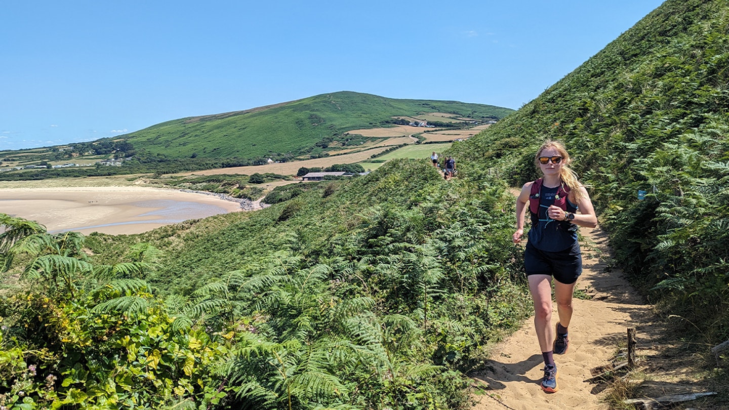 runner in sunglasses on beach path