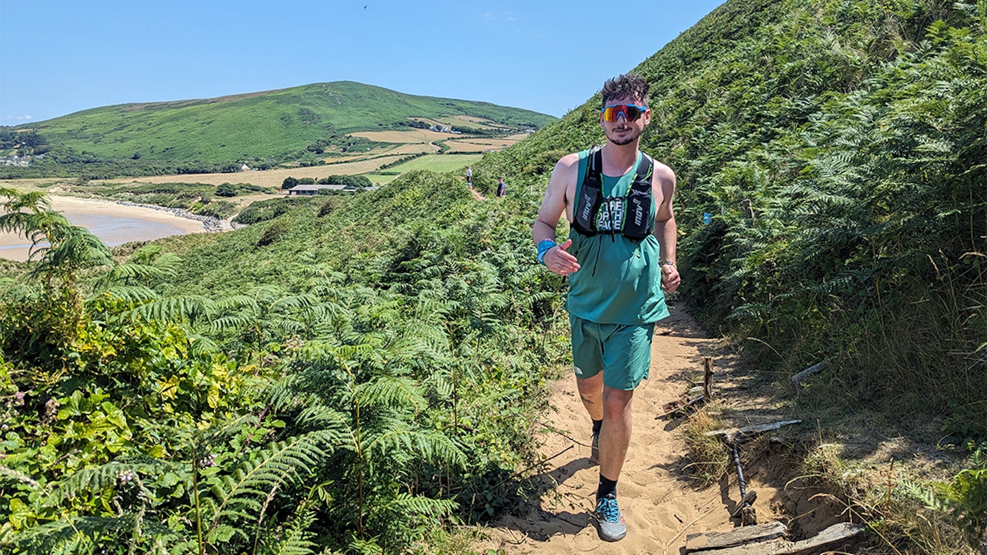 runner in sunglasses on beach path