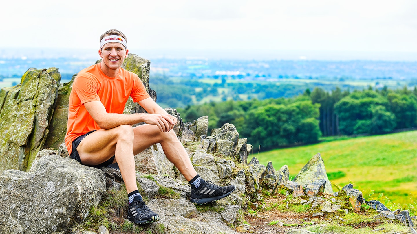 tom evans sits on rock