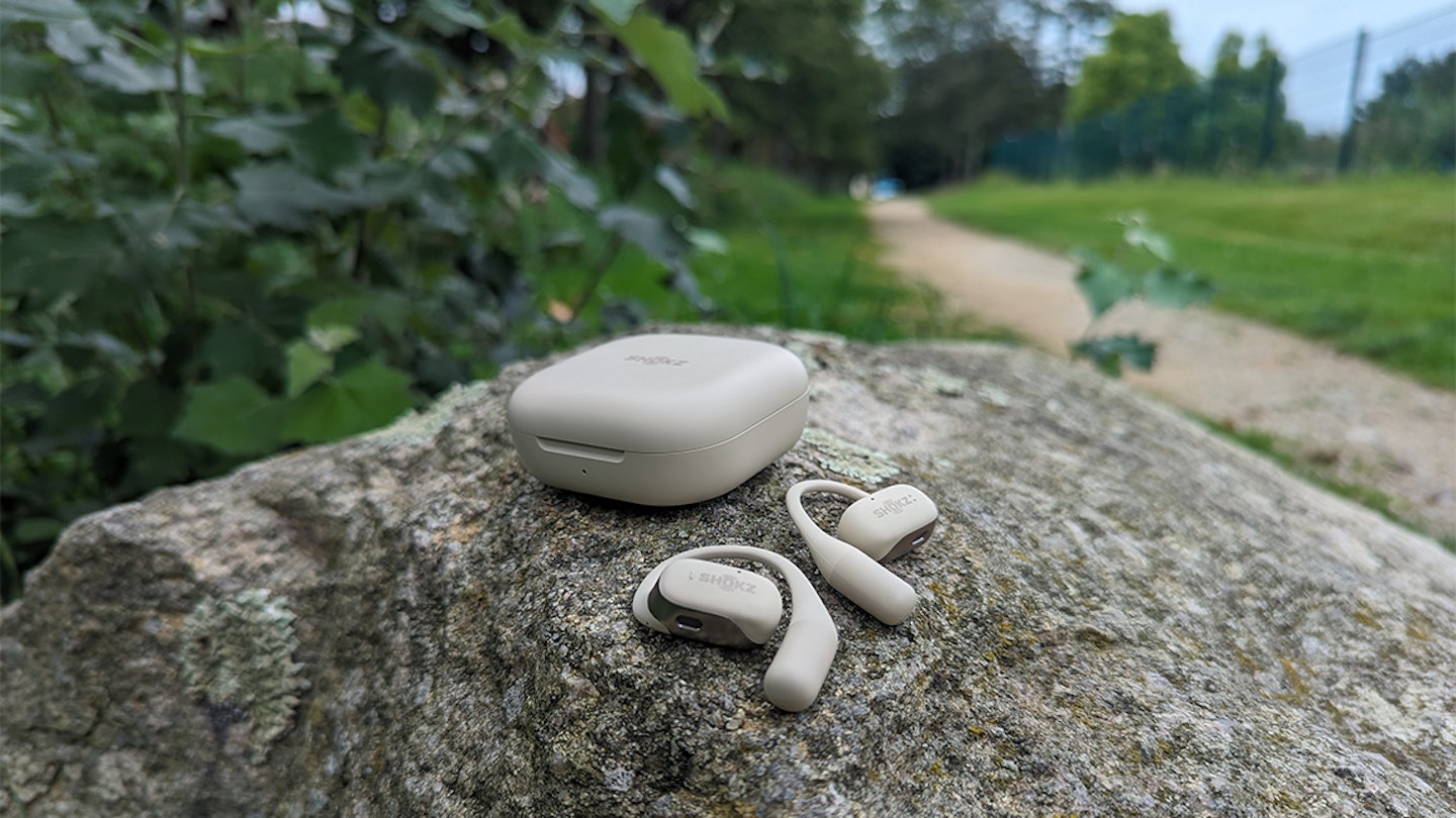 shokz openfit running earbuds on a rock