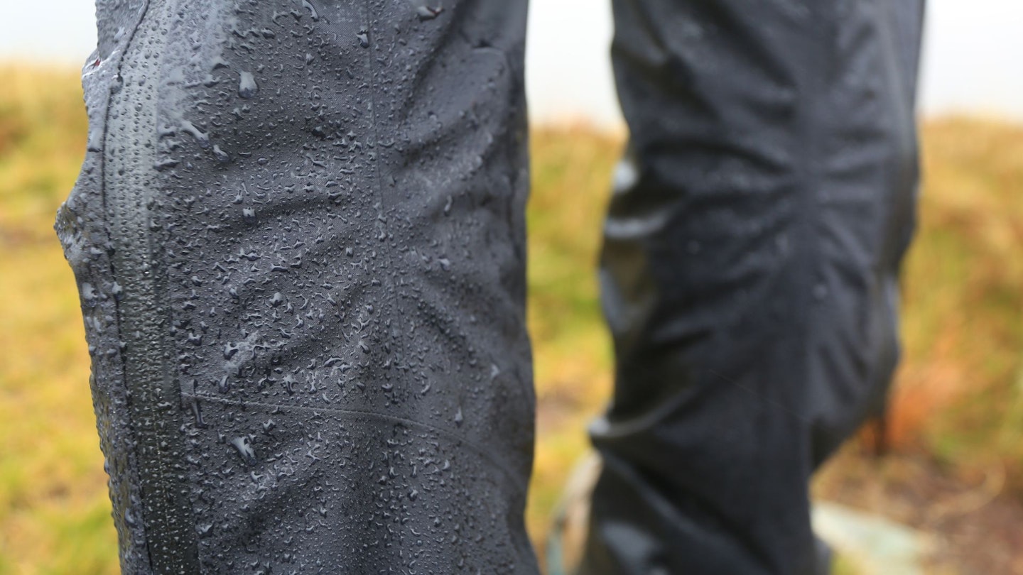 Closeup of water beading on a hiker's waterproof trousers