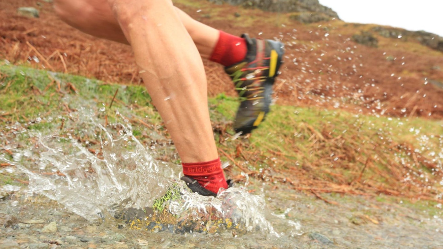 Fell running shoes splashing through water