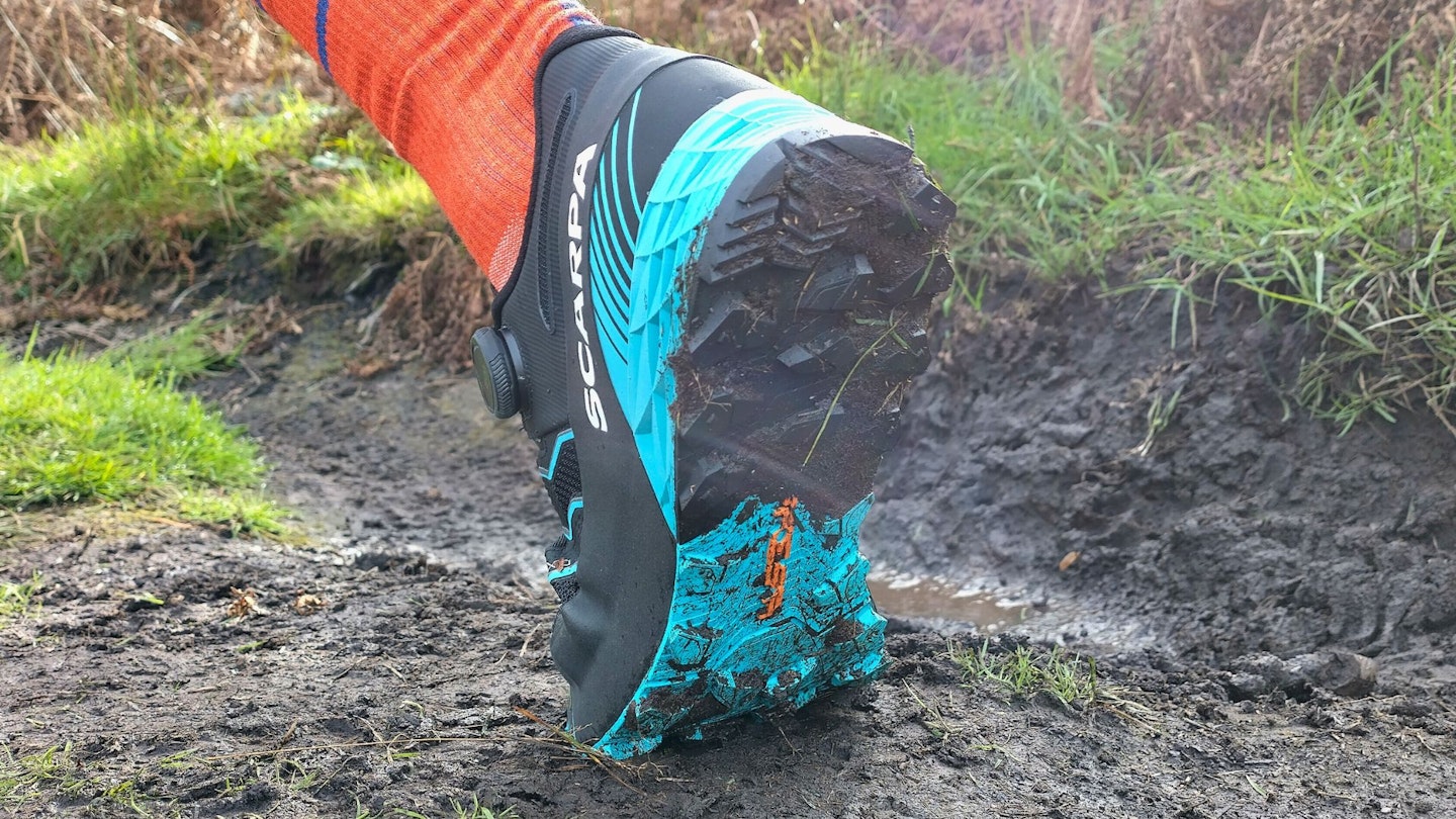 Running through mud wearing Scarpa Ribelle Run Kalibra ST