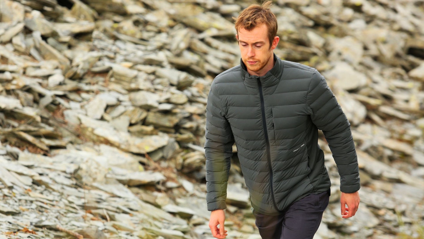 Hiker walking wearing Artilect Divide Fusion Stretch Jacket