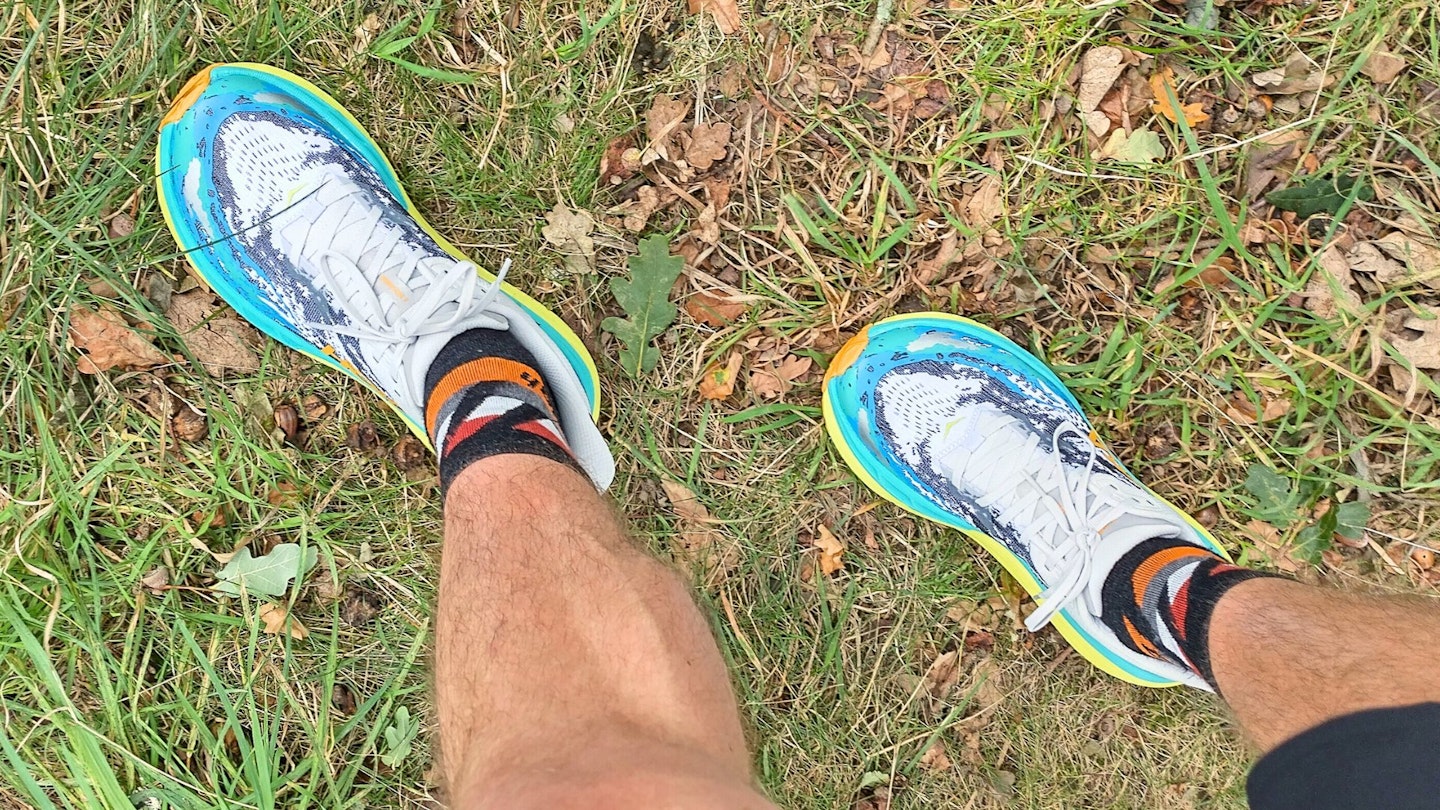 First person view looking down at Hoka Stinson 7 on feet