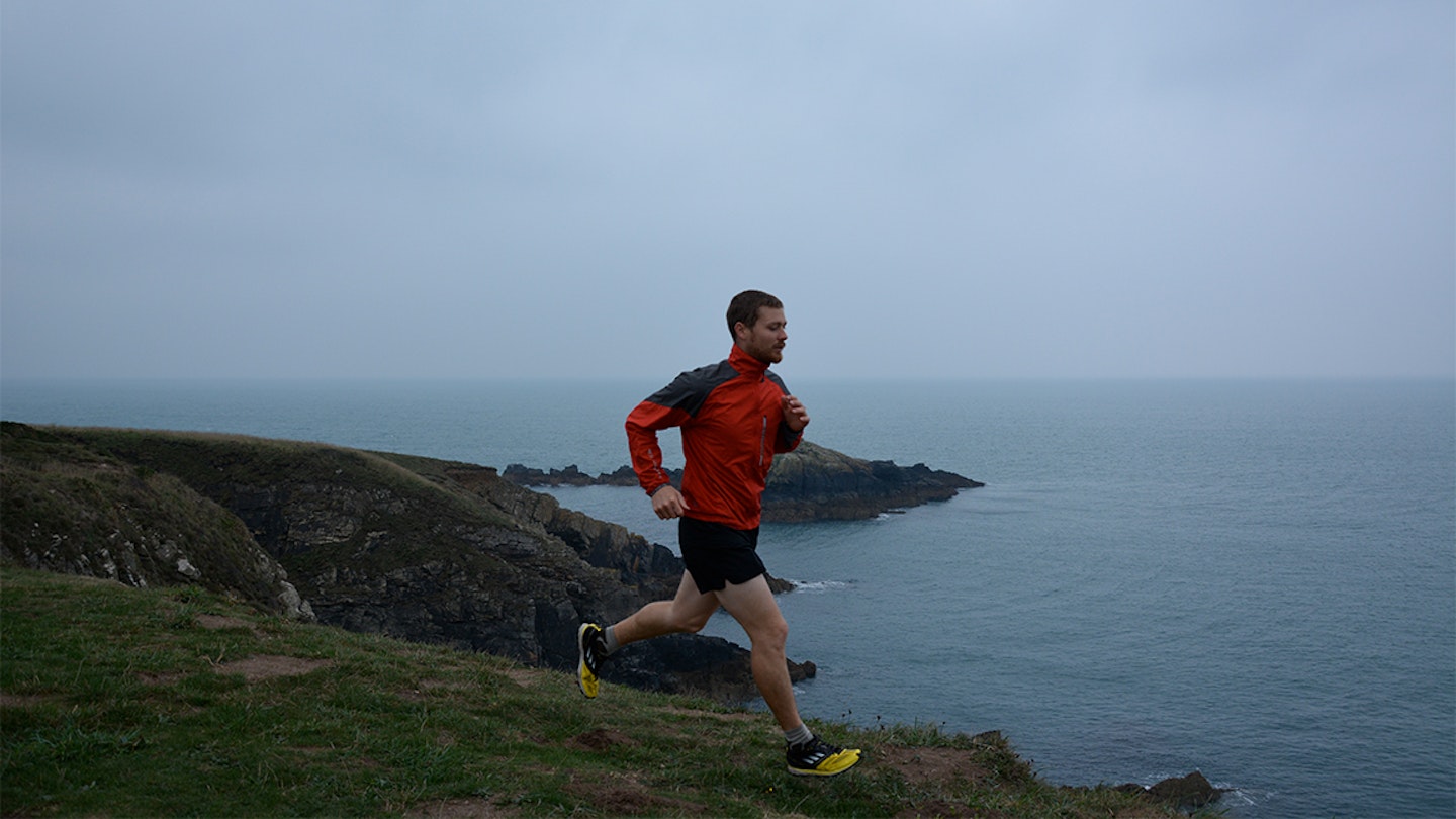 runner along a seaside trail