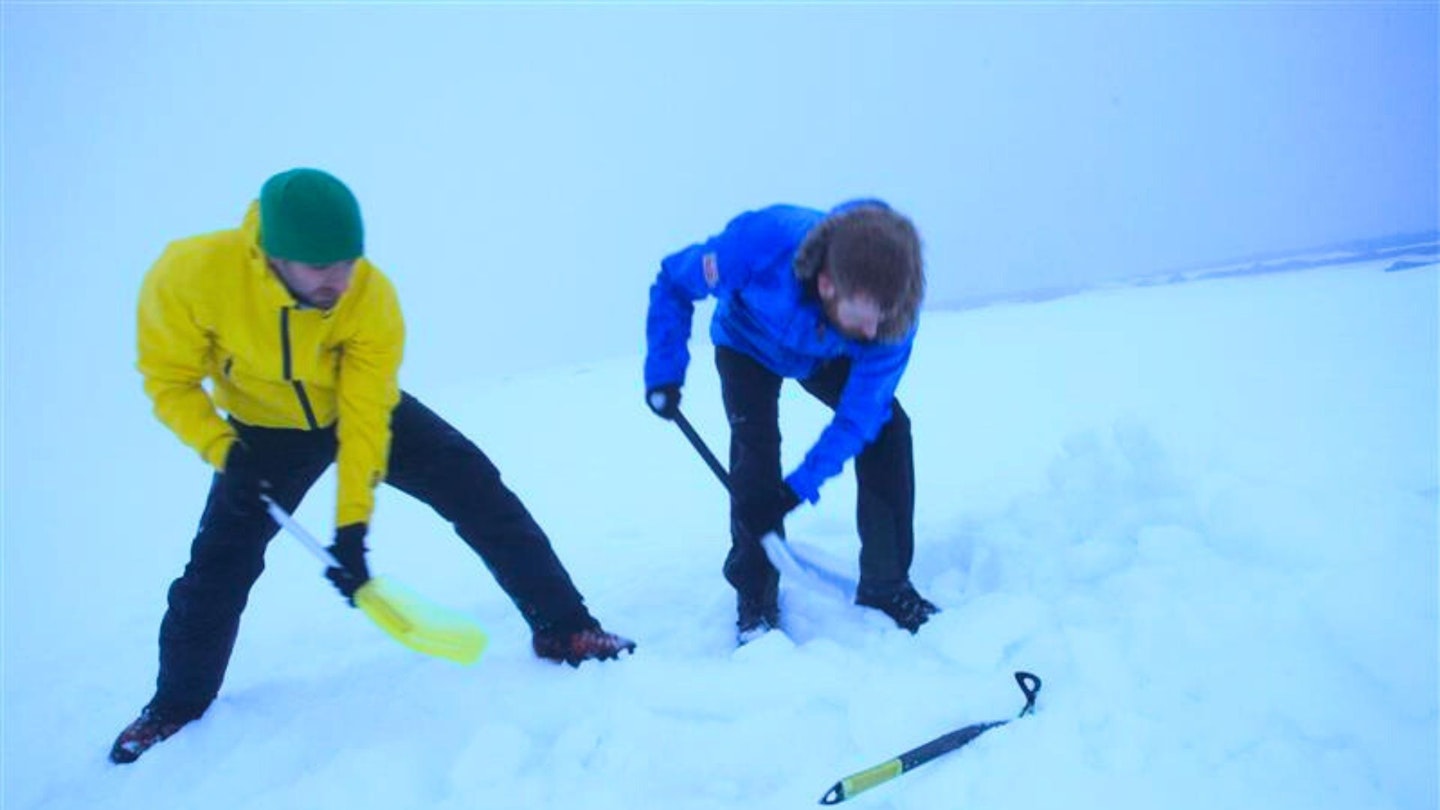 Hikers using snow shovels