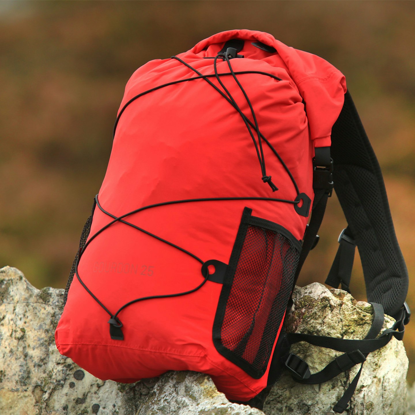 Alpkit Gourdon waterproof backpack on a rock