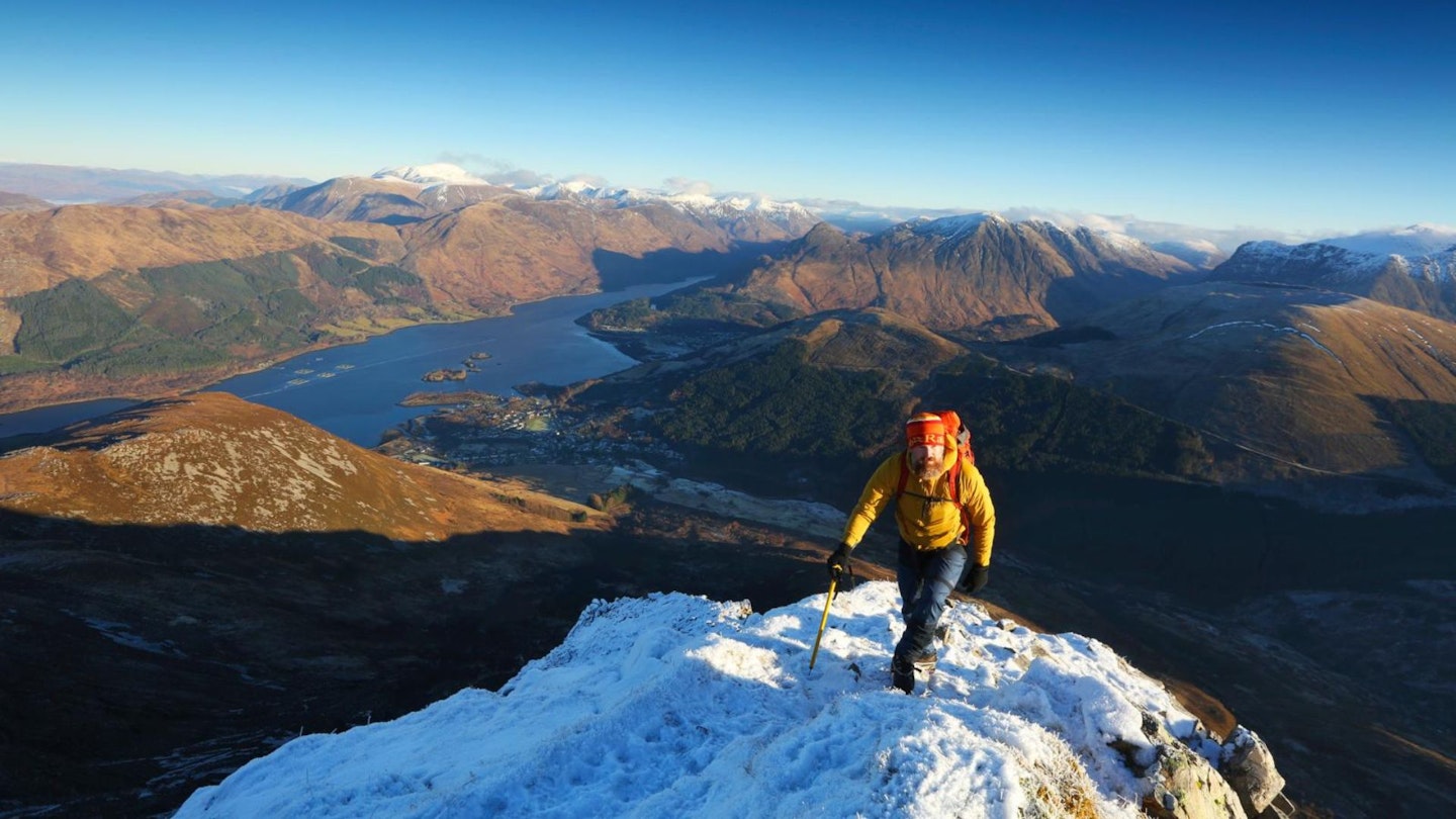 Winter hiker climbing Schoolhouse Ridge in the Scottish Highlands