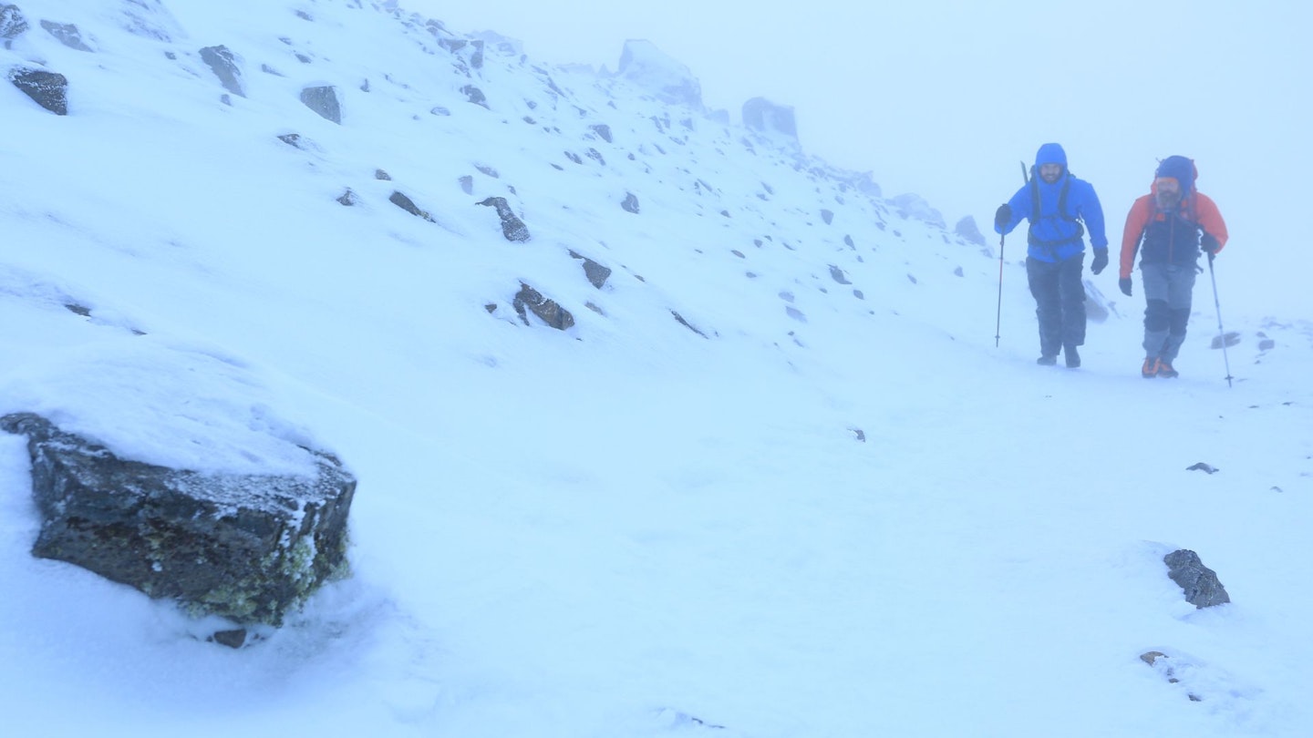 Passing navigation cairn on Ben Nevis summit plateau