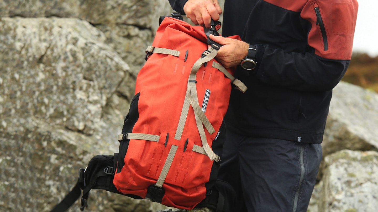 hiker holding Ortlieb Atrack 35 waterproof backpack