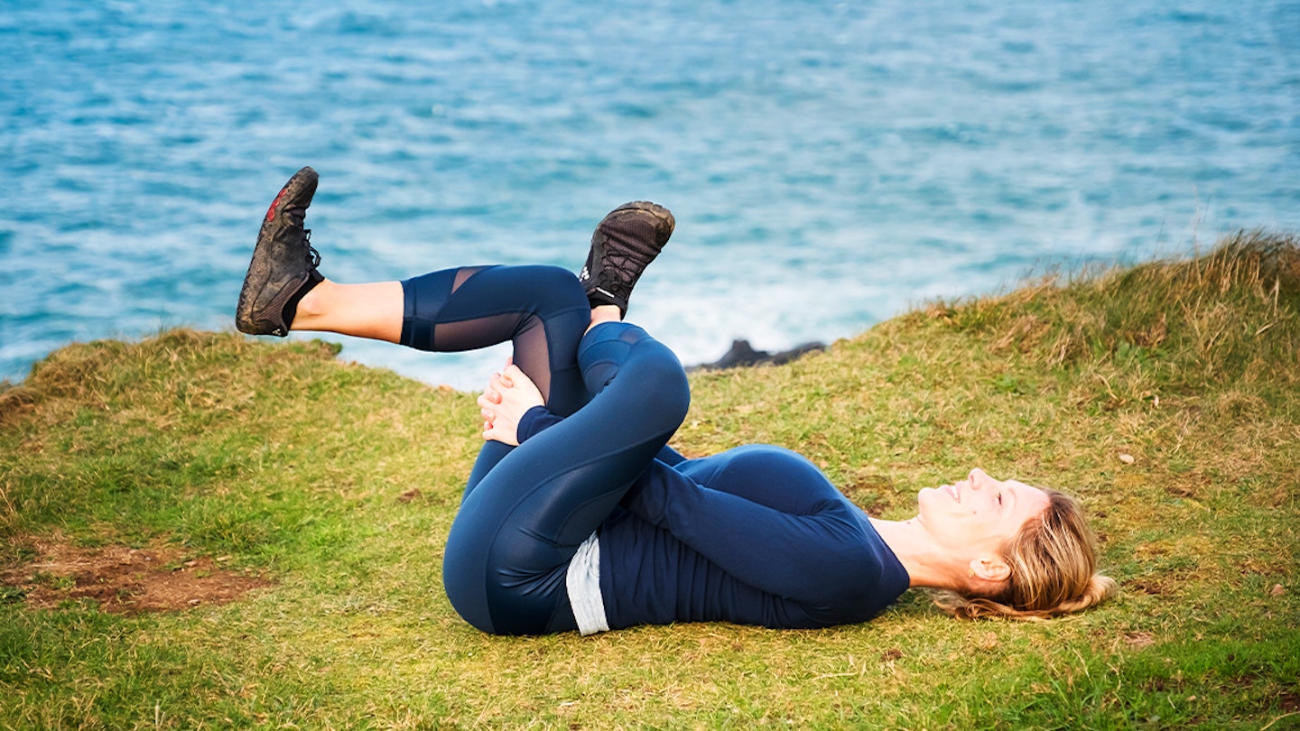 woman doing yoga on grass