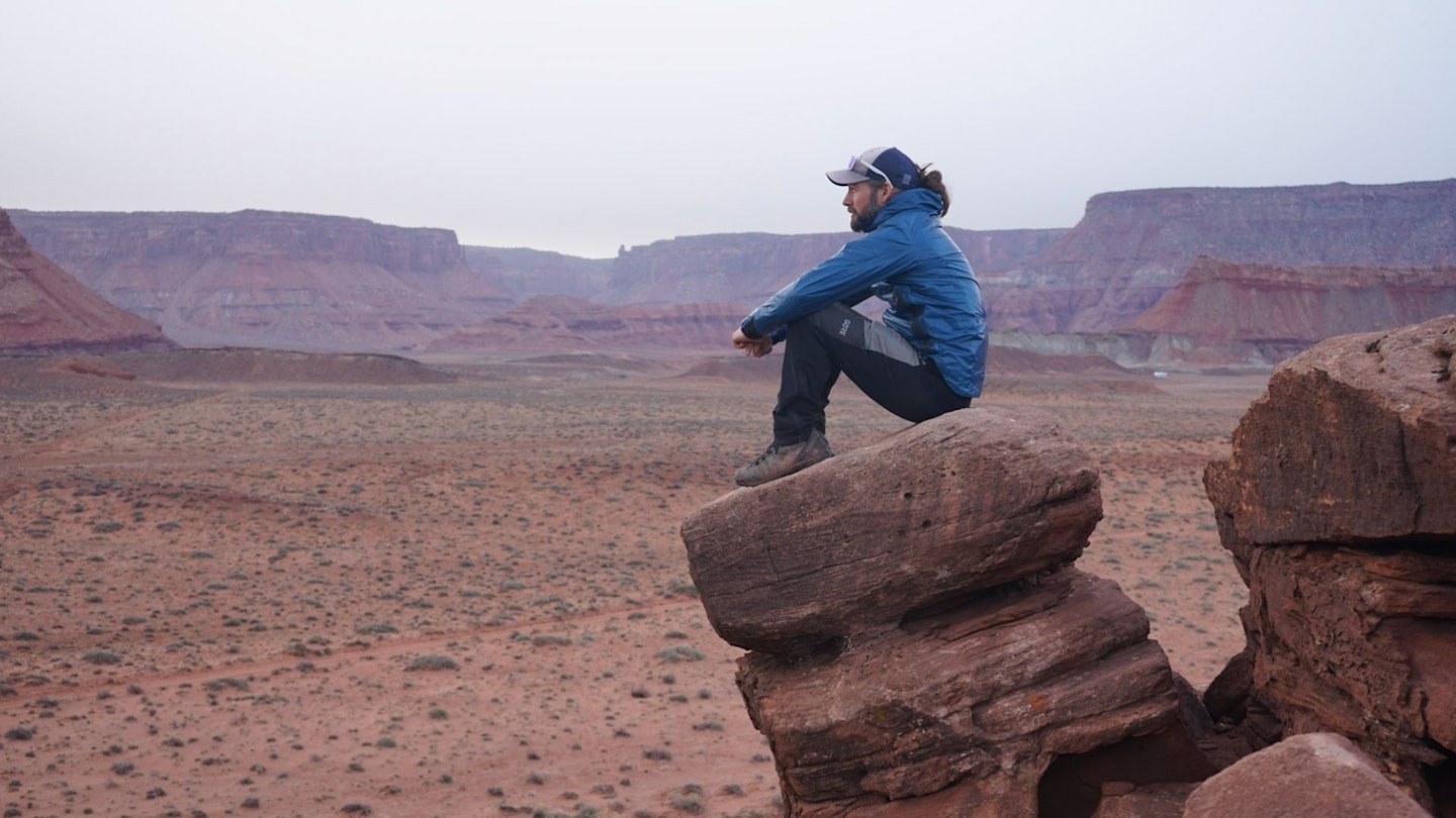 Hiker resting on a rock Cotswold Outdoor kit