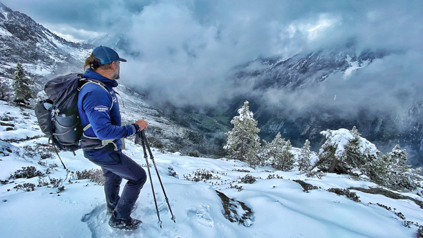 Hiker on a snowy mountain trail