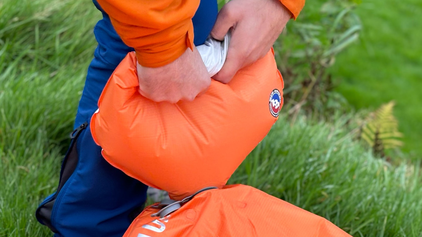 Blowing up a camping mattress with the air bag